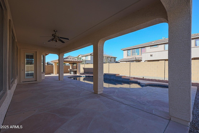 view of patio featuring ceiling fan and a fenced in pool