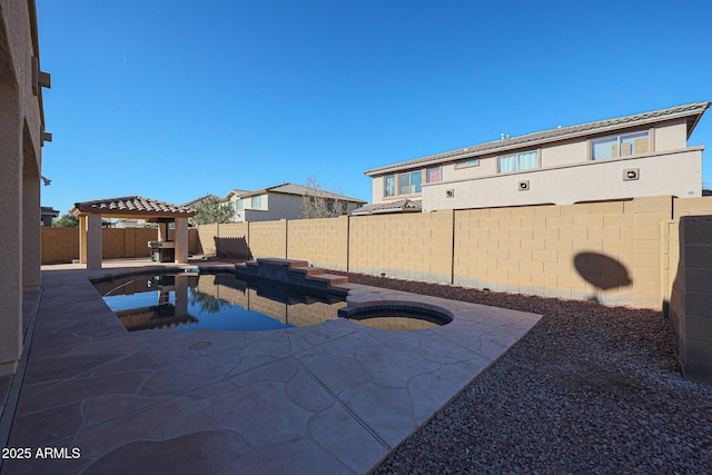 view of swimming pool with an in ground hot tub, a gazebo, and a patio area