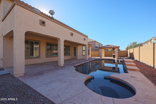 view of pool with an in ground hot tub and a patio