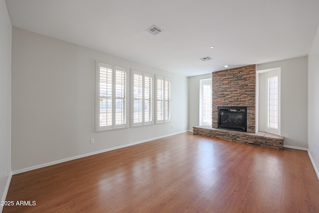 unfurnished living room featuring hardwood / wood-style flooring and a fireplace