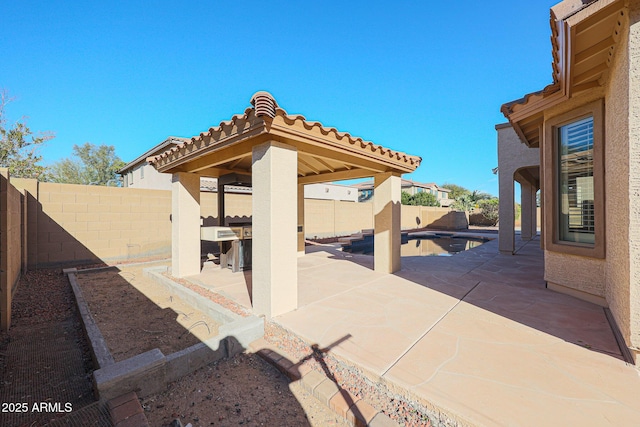 view of patio / terrace featuring a gazebo and a fenced in pool