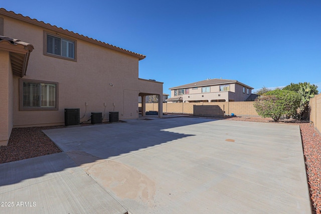 view of side of property featuring cooling unit and a patio