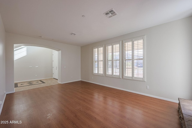 empty room with hardwood / wood-style floors