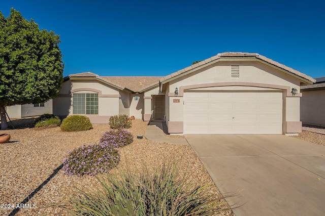 ranch-style house featuring a garage