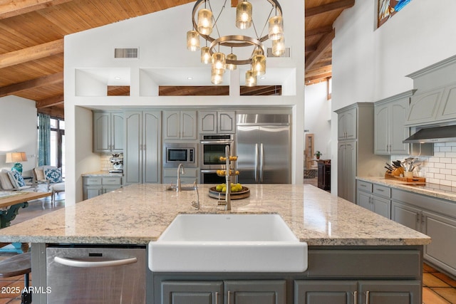 5540 E Mercer Ln, Scottsdale, AZ 85254 - kitchen with gray cabinets, a wooden ceiling with exposed beams, built in appliances, backsplash, and a center island with sink