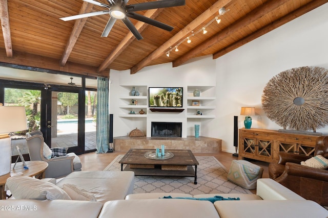 5540 E Mercer Ln, Scottsdale, AZ 85254 - living room with wood ceiling, a ceiling fan, a tile fireplace, built in shelves, and wood finished floors