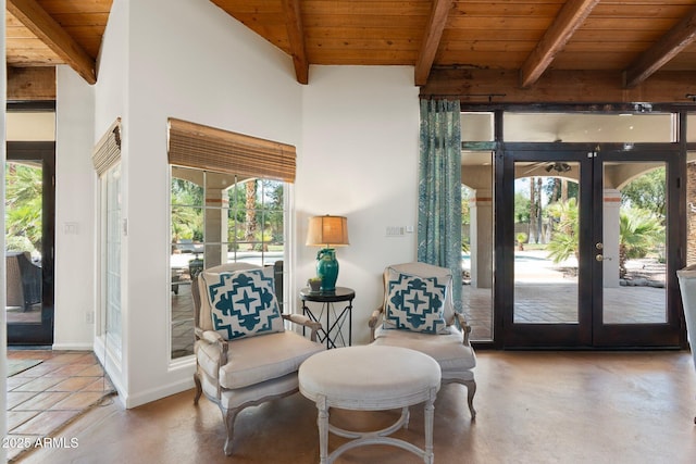 5540 E Mercer Ln, Scottsdale, AZ 85254 - sitting room featuring french doors, a wooden ceiling with exposed beams, and finished concrete flooring