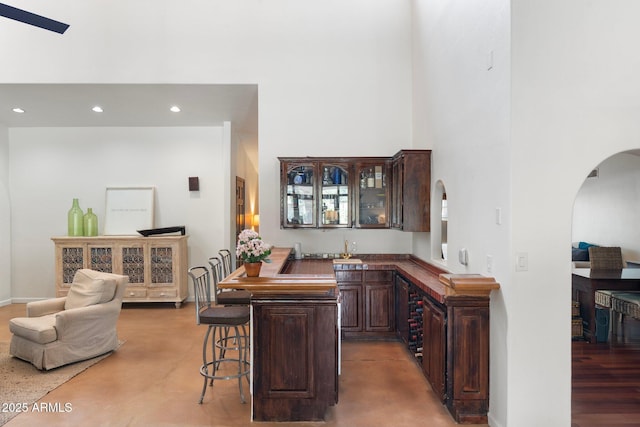 5540 E Mercer Ln, Scottsdale, AZ 85254 - indoor wet bar with arched walkways, a towering ceiling, recessed lighting, and concrete floors