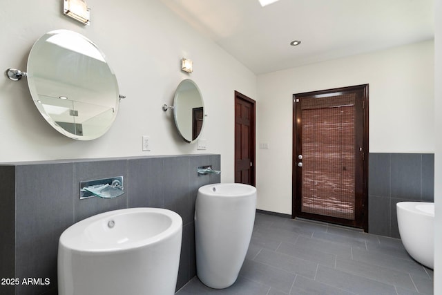 5540 E Mercer Ln, Scottsdale, AZ 85254 - bathroom with tile walls, wainscoting, and tile patterned flooring
