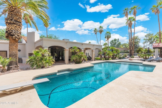 5540 E Mercer Ln, Scottsdale, AZ 85254 - swimming pool with a patio area, french doors, and a diving board