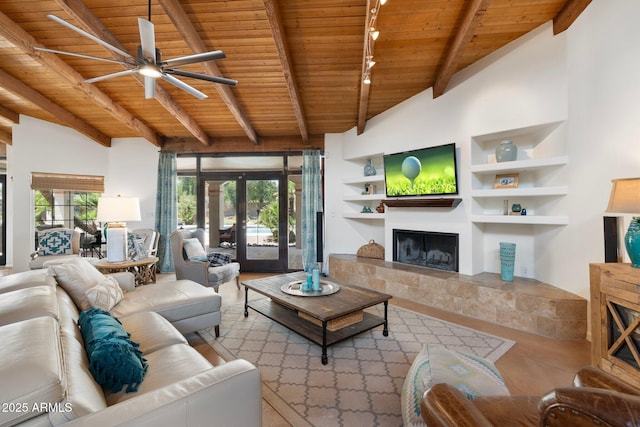 5540 E Mercer Ln, Scottsdale, AZ 85254 - living area featuring wooden ceiling, ceiling fan, a tile fireplace, track lighting, and built in shelves