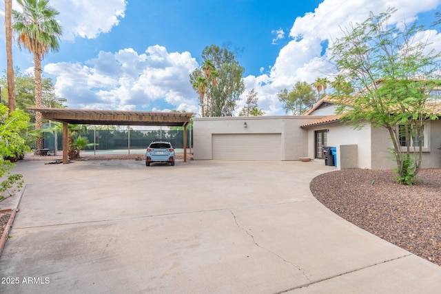 5540 E Mercer Ln, Scottsdale, AZ 85254 - view of side of property with stucco siding, a garage, concrete driveway, and a tile roof