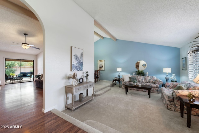 living room featuring ceiling fan, hardwood / wood-style flooring, lofted ceiling with beams, and a textured ceiling