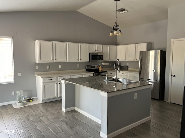 kitchen with a center island with sink, white cabinetry, and appliances with stainless steel finishes