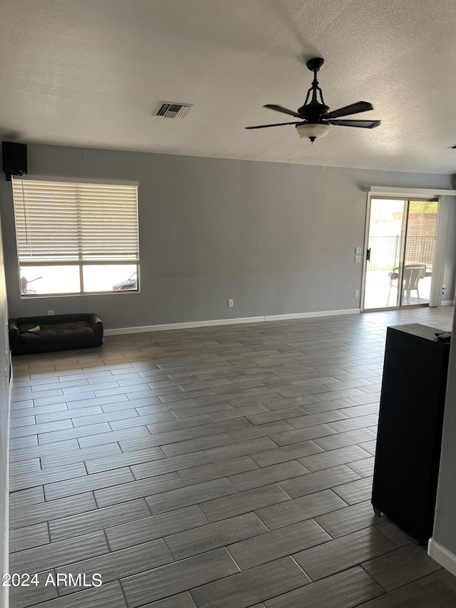 spare room with plenty of natural light and ceiling fan