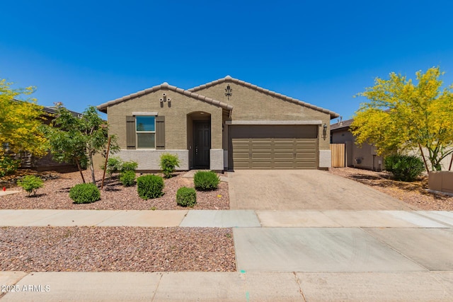 17344 W Red Fox Rd, Surprise, AZ 85387 - ranch-style house with an attached garage, stucco siding, driveway, and a tile roof