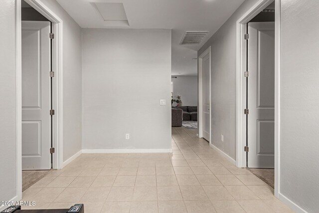 17344 W Red Fox Rd, Surprise, AZ 85387 - hallway featuring light tile patterned flooring, baseboards, visible vents, and attic access