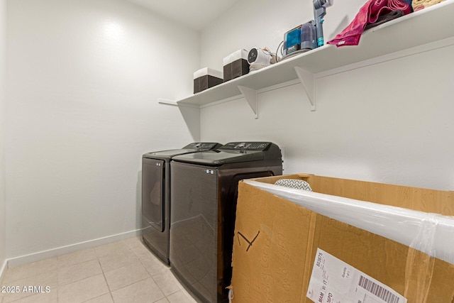 17344 W Red Fox Rd, Surprise, AZ 85387 - clothes washing area with washing machine and clothes dryer, light tile patterned floors, laundry area, and baseboards