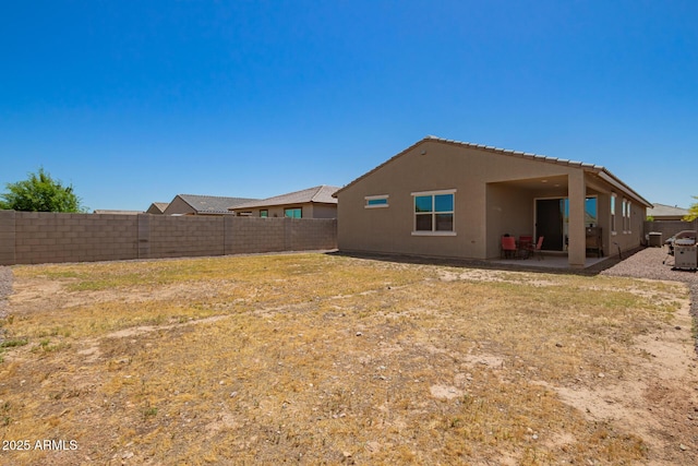 17344 W Red Fox Rd, Surprise, AZ 85387 - back of house featuring a fenced backyard, a patio, and stucco siding