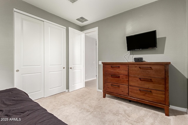 17344 W Red Fox Rd, Surprise, AZ 85387 - bedroom with light colored carpet, baseboards, visible vents, and a closet