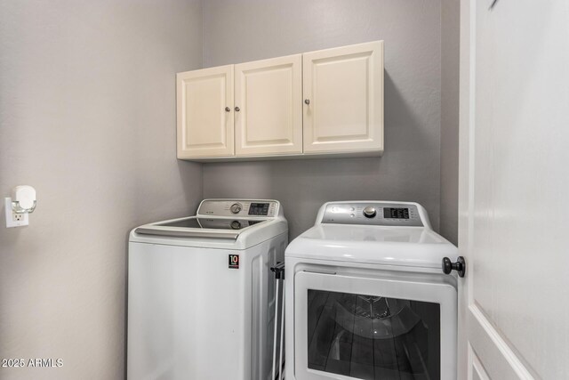 laundry area with cabinet space and separate washer and dryer