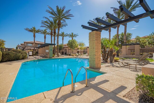 pool with a patio area and a pergola