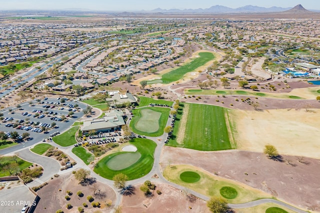 drone / aerial view featuring view of golf course and a mountain view