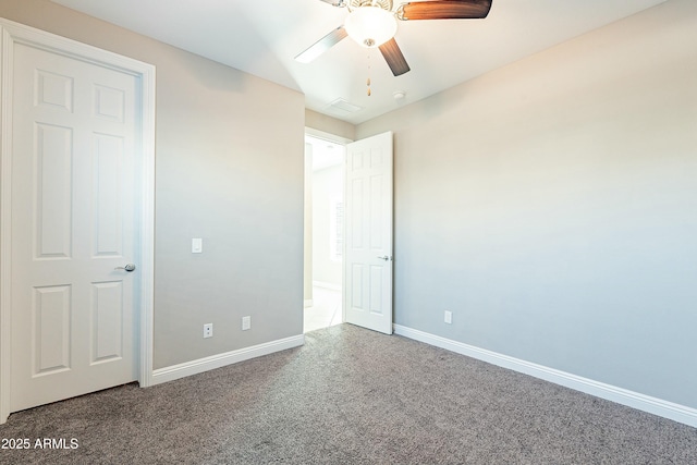 unfurnished bedroom featuring carpet floors, visible vents, ceiling fan, and baseboards