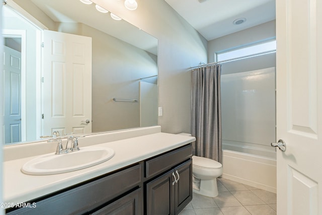 bathroom with vanity, tile patterned flooring, shower / bath combo with shower curtain, and toilet