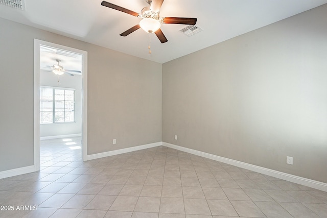 empty room featuring visible vents, ceiling fan, baseboards, and light tile patterned floors