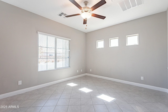 unfurnished room featuring ceiling fan, visible vents, and baseboards