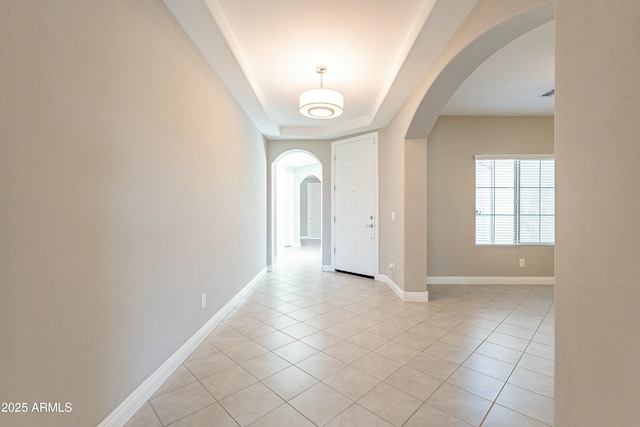 foyer featuring arched walkways, visible vents, baseboards, and light tile patterned floors