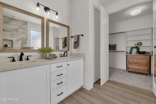 bathroom featuring a shower and vanity