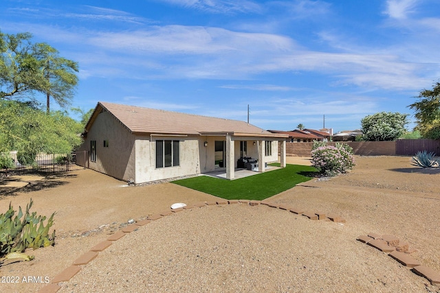 back of house featuring a patio area