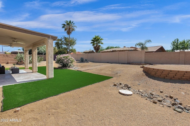 view of yard with a patio and ceiling fan