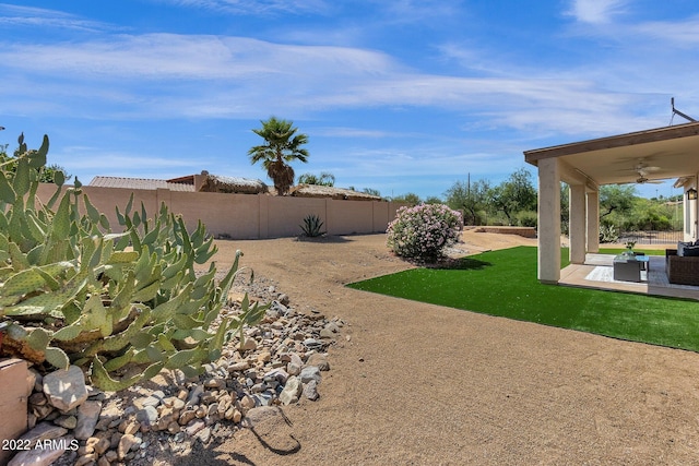 view of yard with a patio area and ceiling fan