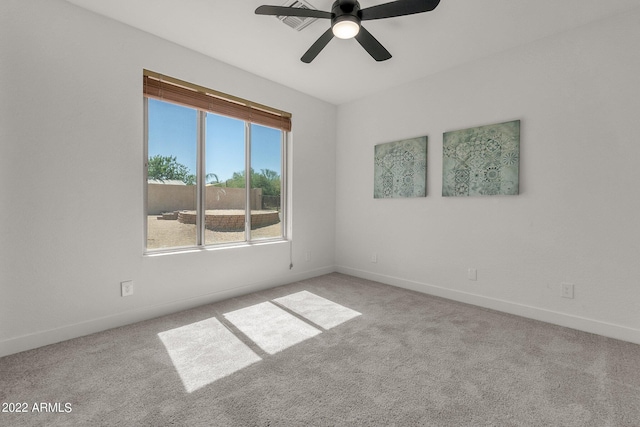 spare room with ceiling fan and light carpet