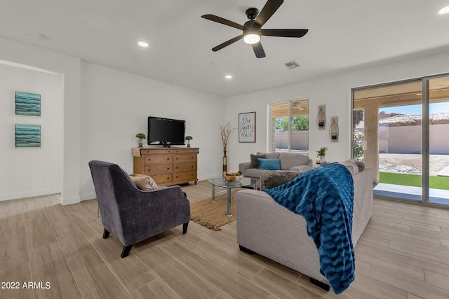 living room featuring ceiling fan and light wood-type flooring