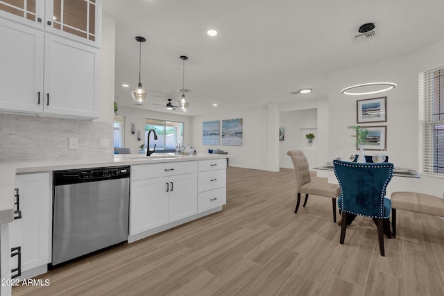 kitchen featuring pendant lighting, dishwasher, sink, ceiling fan, and white cabinetry