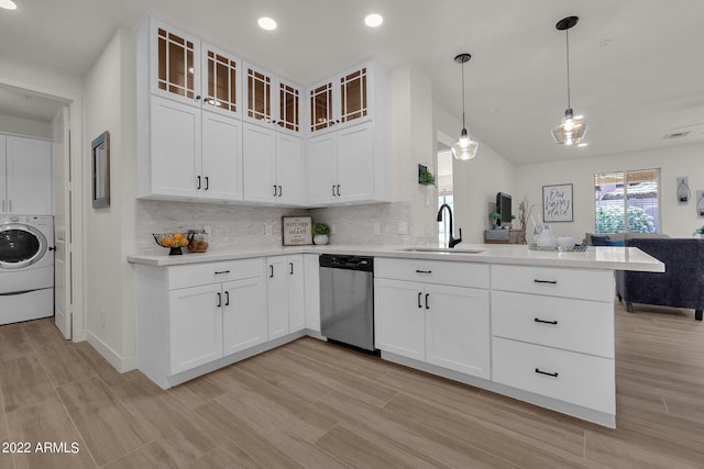 kitchen featuring sink, stainless steel dishwasher, washer / clothes dryer, pendant lighting, and white cabinets