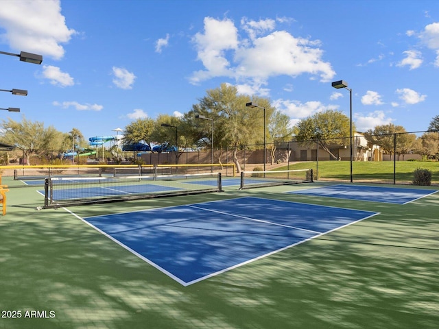 view of tennis court with fence