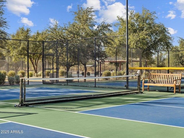 view of tennis court with fence