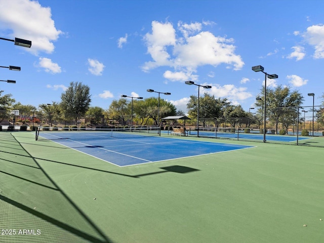 view of tennis court with fence