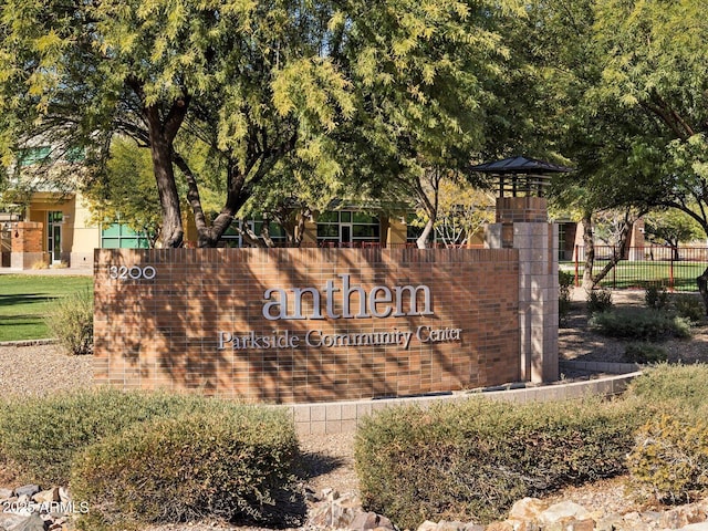 community / neighborhood sign featuring fence