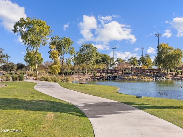 view of community with a lawn and a water view