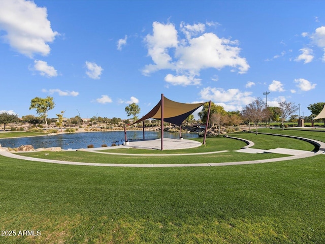 view of community featuring a yard and a water view