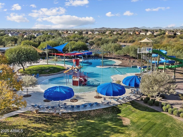 view of pool featuring a mountain view and playground community