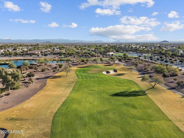 aerial view featuring golf course view and a water and mountain view