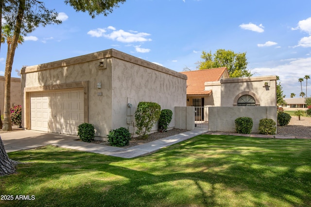 18818 N 95th Ave, Peoria, AZ 85382 - view of front facade featuring concrete driveway, stucco siding, an attached garage, a tiled roof, and a front yard