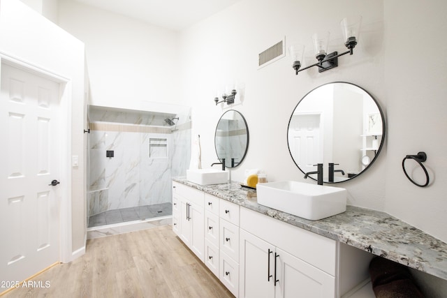 18818 N 95th Ave, Peoria, AZ 85382 - bathroom featuring visible vents, wood finished floors, a sink, and a marble finish shower